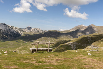 Wooden bench in Durmitor National Park, Montenegro, offering a breathtaking view of the mountain...