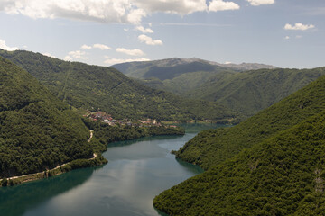 Obraz premium Panoramic view of Piva Canyon in Montenegro, a stunning natural formation located near the Durmitor National Park and the town of Pluzine. Summer mountain landscape with rocky cliffs