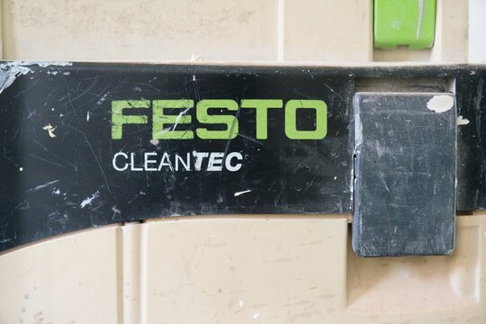Worn Festool CLEANTEC Logo on Dirty Plastic Surface