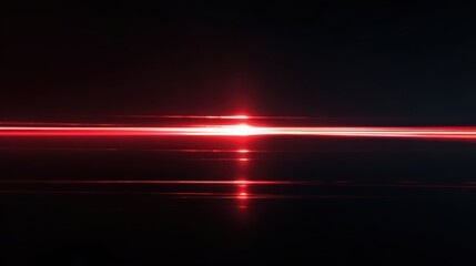 Obraz premium Abstract red laser light streak on a black background, representing speed, innovation, and modern technology.