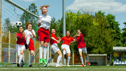 Female soccer players in goalmouth action during intense match. Concept of summer games teamwork,...