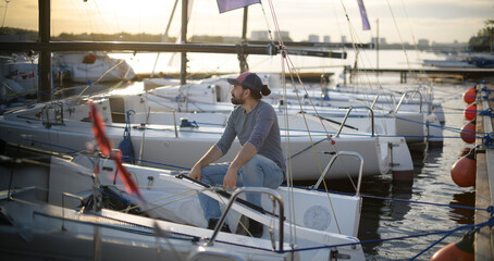 Preparation for the regatta at the yachting school at the marina with sailing yachts.