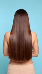 Fototapeta premium Long with healthy hair on woman, and blue background.