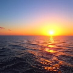 Fototapeta premium A calm ocean glows under the golden sunset, painting the sky with warm hues. The tranquil sea mirrors the fading light, offering a peaceful end to the day.