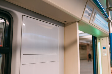 An advertising poster on the wall of a train car in the subway. Free space.