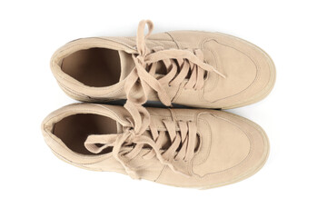 Pair of stylish beige sneakers on white background, top view