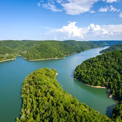 Serene lake winding through lush hills