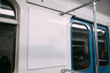 An advertising poster on the wall of a train car in the subway. Free space.