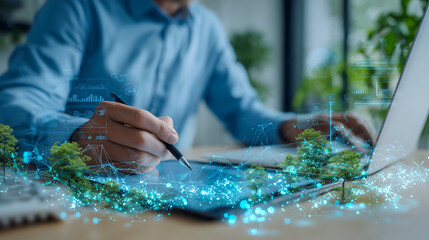 Man using laptop with glowing digital network overlay and green plant elements