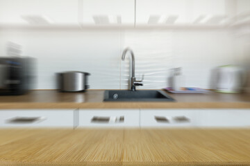 Wooden  table top on blur kitchen counter room background