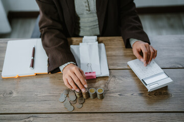 Unrecognizable woman holds receipts pencil uses laptop plans budget manages expenses calculates...