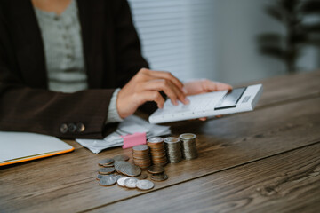 Unrecognizable woman holds receipts pencil uses laptop plans budget manages expenses calculates...