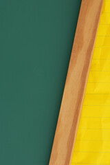 Green chalkboard with yellow ruled loose leaf notebook paper background