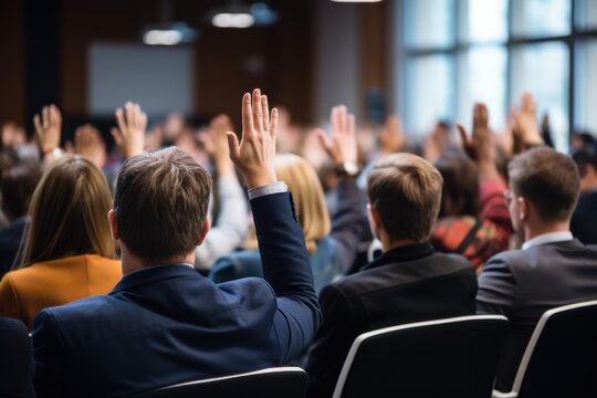 Audience engagement at a business conference in a modern meeting room interactive q&a session professional environment attendees raising hands