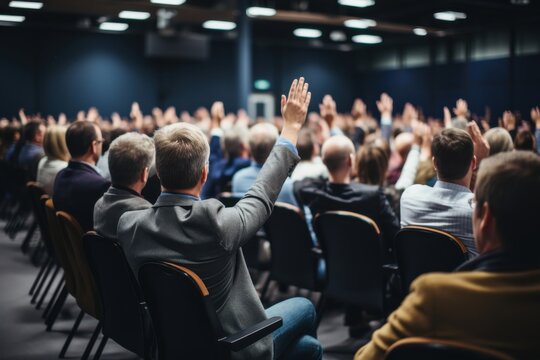 Engaging conference session with attentive audience raising hands business venue event photography professional environment wide-angle viewpoint interaction concept