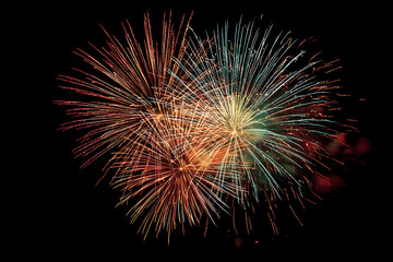 Fototapeta premium Explosive celebration bursts illuminate the night sky with vibrant colors and dazzling light.