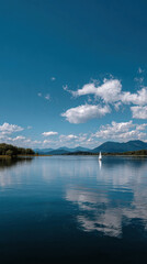Peaceful river calm water blue sky white cloud mountain reflection tranquil landscape sailboat serene nature outdoor