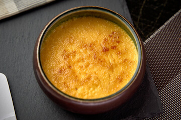 A Creamy Custard Dessert with a Crisped Sugar Topping Served in a Rustic Bowl, Perfect for Satisfying Sweet Cravings and Enjoying Rich Flavors