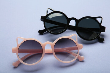 Kids sunglasses on purple background. Sun protection