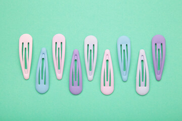 Set of pastel hairpins on mint background.