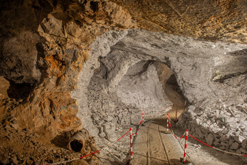 Interior of the Dossena mine with colored stones for an artistic installation.