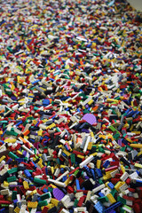 
Vertical background of a large number of children's toy building blocks in various colors