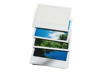 Fototapeta premium Stack of instant photos with sky and foliage isolated on transparent background