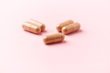 Ginseng capsules on bright background. Soft focus. Close up. Copy space	