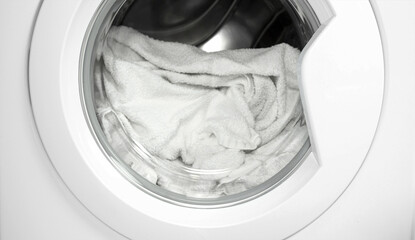 Process of cleaning white cloth in washing machine, closeup