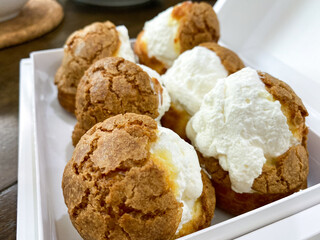 Freshly Baked Cream Puffs in a White Box