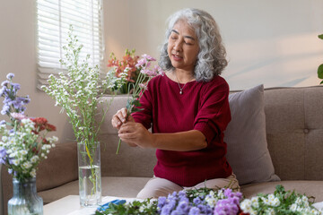 Elderly Woman Arranging Fresh Flowers at Home