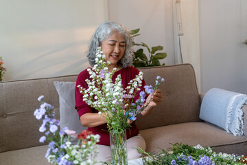 Elderly Woman Arranging Fresh Flowers at Home