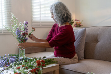 Elderly Woman Arranging Fresh Flowers at Home