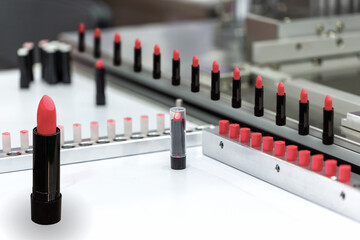 A lipstick vial filling machine in a cosmetics factory.