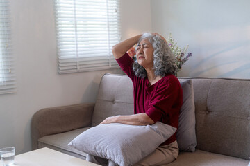 Elderly Woman Suffering from Headache at Home