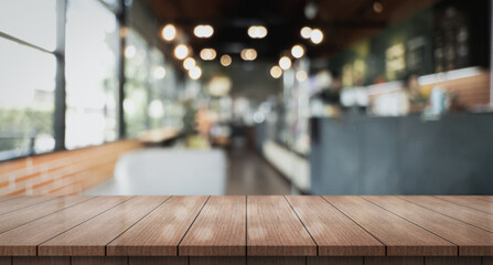 Empty wooden table top with lights bokeh on blur restaurant background.