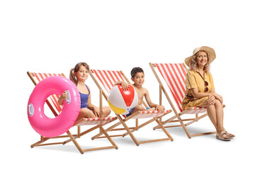 Children and a woman seated in beach chairs
