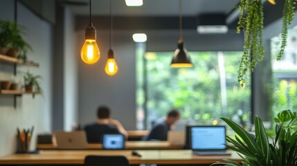 Modern office interior design featuring warm light bulbs, green plants, and a collaborative workspace atmosphere