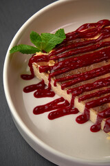 Delicious Dessert Slice with Berry Sauce and Fresh Mint Garnish Showcasing Culinary Artistry for Sweet Tooth Lovers