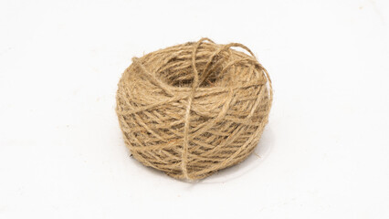 A rustic roll of natural jute twine on a simple white background, perfect for crafting, packaging, or eco-friendly themes