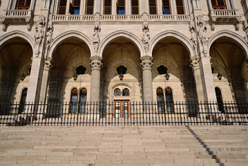 elevation detail of the neo gothic stone parliament building in budapest along the danube river. tall gothic arched windows. famous historic landmark building. popular tourist destination