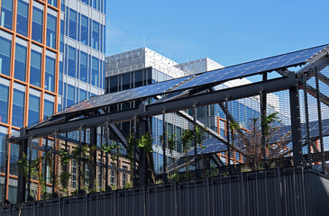 Mesh Covered Rooftop Recreation area with Modern Office Buildings in Background  