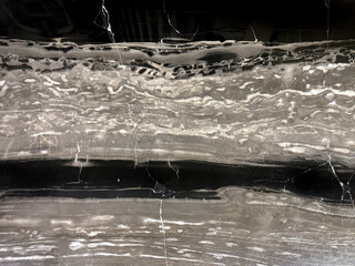 Natural black forest marble, or black and white marble slab pattern. Black honed marble with wavy...