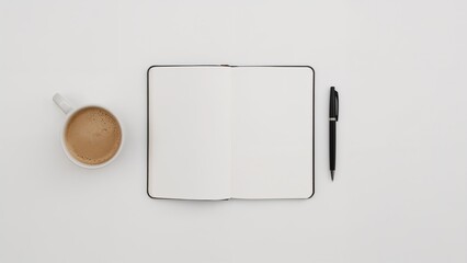 Overhead view of a coffee cup, open notebook, and pen on a white surface.