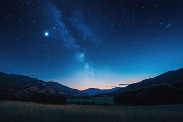 Milky Way over a valley at night.  Stars, mountains, and field