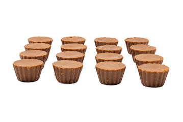 Fudge Cups Angled View White Background. An angled view of three rows of fudge cups, showing the ridged sides and smooth tops. The chocolate treats are isolated on a white background.