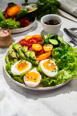 Healthy Salad Bowl with Avocado, Eggs, Tomatoes and Cucumbers, 