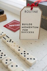 Routine Tag with Inspirational Message and Dominoes in Workspace