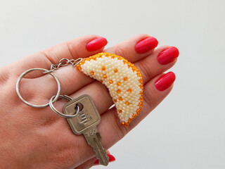 Hand holding a colorful keychain