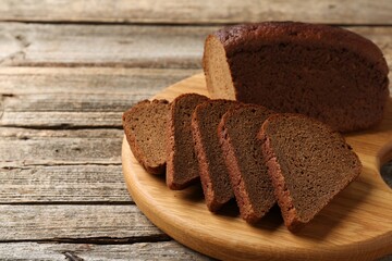 Pieces of fresh rye bread on wooden table, closeup. Space for text